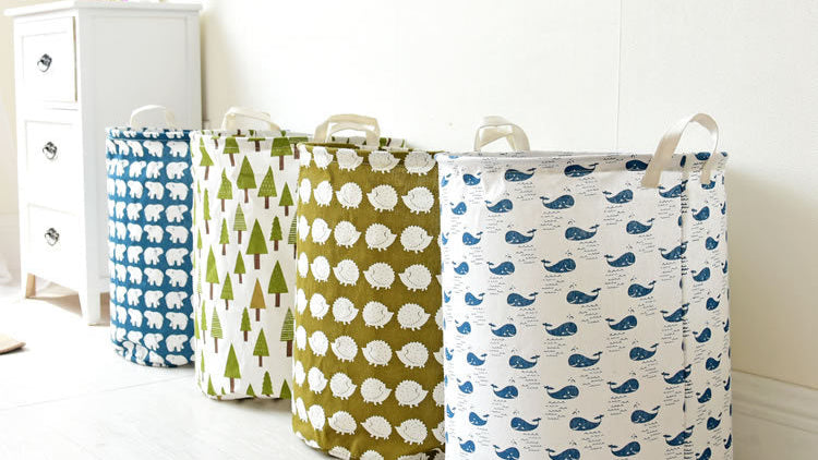 Three fabric storage bins with different patterns on a white surface.